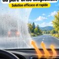 Une femme nettoie son pare-brise avec une solution maison pour éliminer le voile.