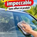 Femme nettoyant un pare-brise de voiture avec soin